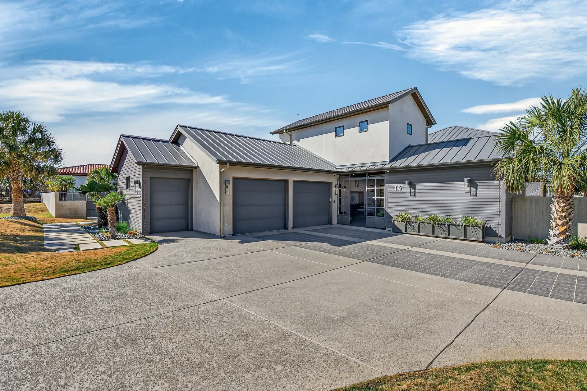 Front exterior with 3-car garage and modern architecture
